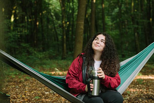 istock Young woman enjoying nature while relaxing in hammock 2240070157