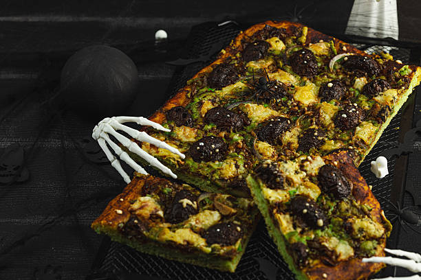 Spooky homemade pizza with green dough, mushroom skulls, and melted cheese. Halloween dark food