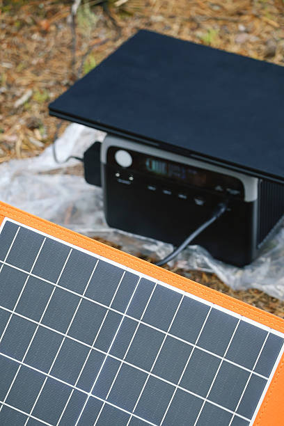 istock Solar Panel Charging Laptop and Power Bank at Forest Camp 2240071915