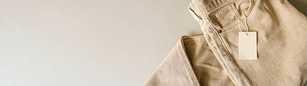 istock Modern jeans with a blank tag on a neutral background. 2240072411