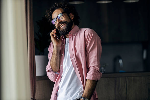 istock Happy man having phone call indoors smiling 2240072553