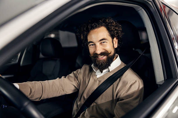 istock Happy man driving car feeling confident and safe 2240072674