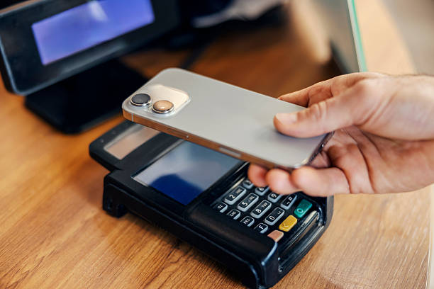istock Hand making contactless payment with smartphone at pos terminal 2240073291