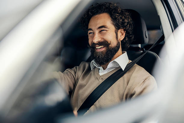 istock Man driving car enjoying safe journey and travel 2240073438
