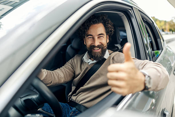 istock Man driver smiling giving thumbs up gesture 2240073465