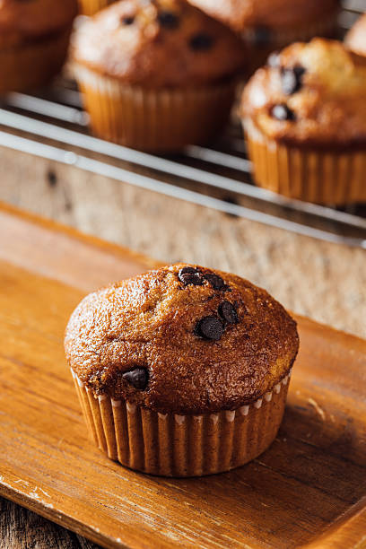 istock Freshly Baked Chocolate Chip Muffin on Wooden Board in Bakery 2240074949