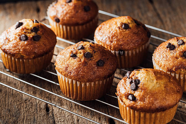 istock Fresh Baked Muffins with Chocolate Chips on Cooling Rack 2240074952