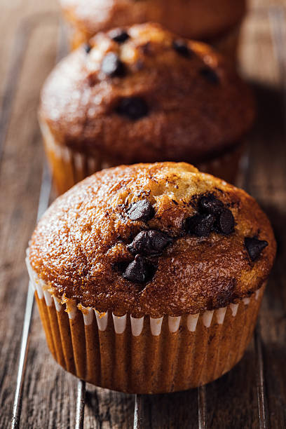 istock Freshly Baked Chocolate Chip Muffin on Rustic Wooden Table 2240075175