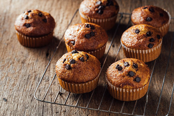 istock Freshly Baked Chocolate Chip Muffins on Rustic Wooden Surface 2240075200