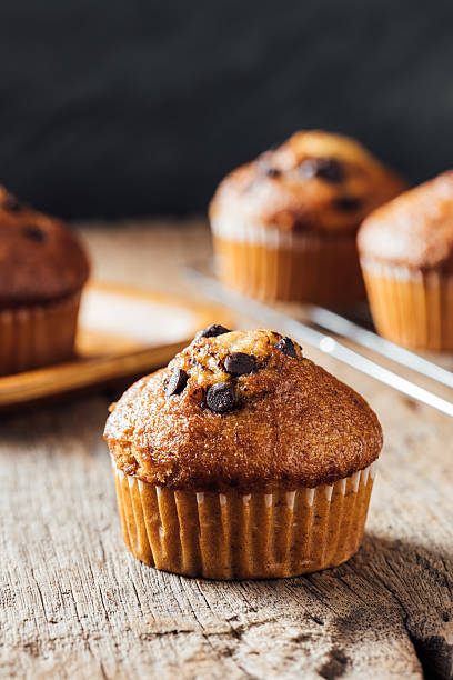 istock Freshly Baked Muffin with Chocolate Chips on Rustic Wooden Table 2240075227