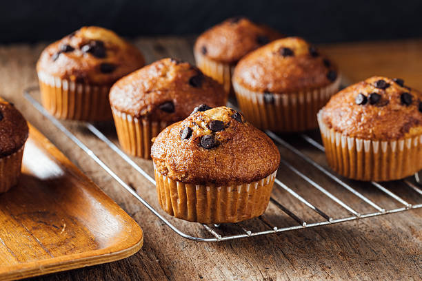 istock Freshly Baked Chocolate Chip Muffins on a Rustic Wooden Table 2240075230