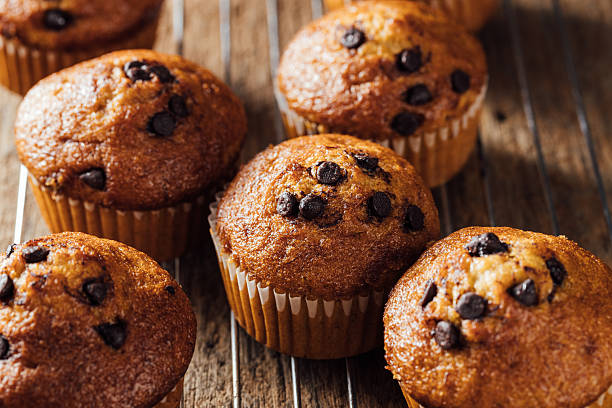 istock Freshly Baked Chocolate Chip Muffins on Rustic Wooden Surface 2240075254