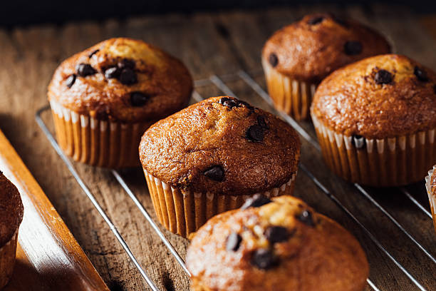 istock Freshly Baked Chocolate Chip Muffins on Rustic Wooden Table 2240075255
