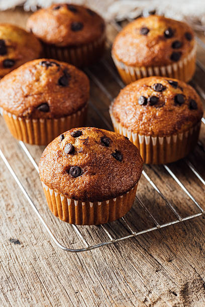 istock Freshly Baked Chocolate Chip Muffins on Wire Rack in Rustic Setting 2240075276