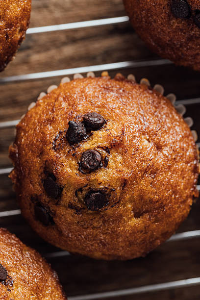 istock Chocolate Chip Muffin on Cooling Rack with Rustic Wooden Background 2240075288