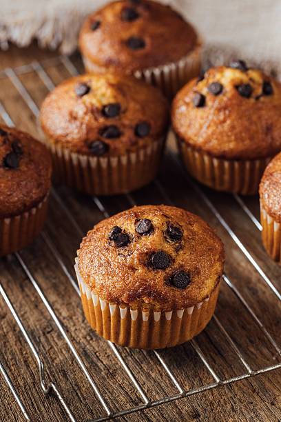 istock Freshly Baked Chocolate Chip Muffins on a Wooden Cooling Rack 2240075298