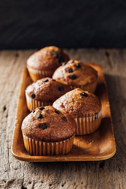 istock Freshly Baked Chocolate Chip Muffins on Wooden Tray Display 2240075608