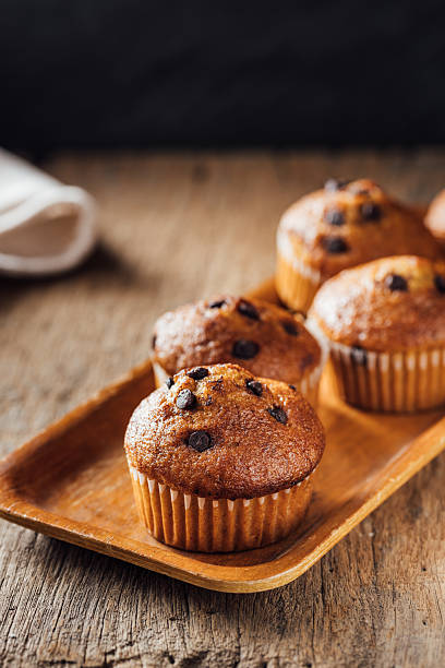 istock Freshly Baked Chocolate Chip Muffins on Wooden Tray Display 2240075785