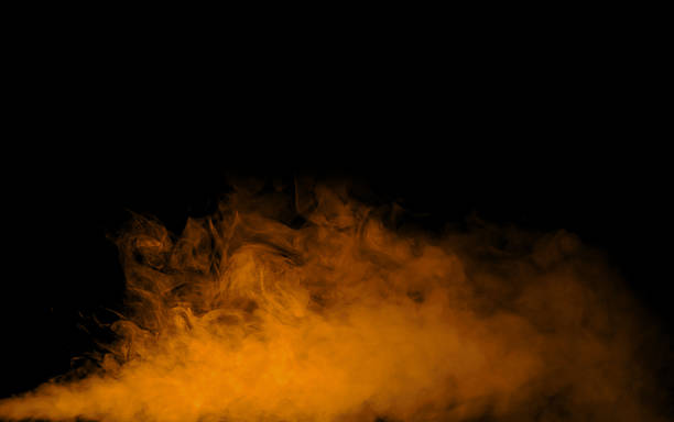 istock Orange smoke or vapor on black background, perfect for fire effect, warm atmosphere, or abstract energy concept. Ideal for advertising, visual design, and cinematic composition. 2240078459