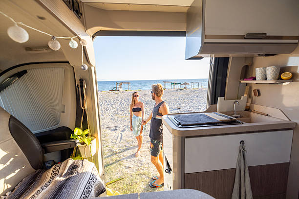 istock Couple Enjoying Beach Vacation from Camper Van 2240079182