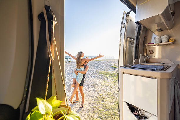 istock Couple Embracing Outside Camper Van at Beach 2240079290