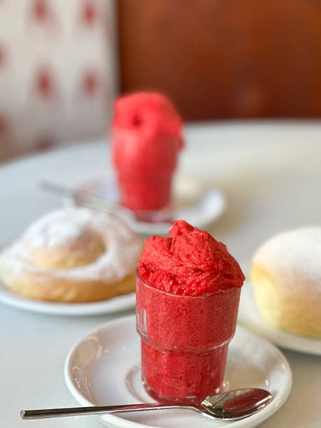 istock Strawberry ice cream in foreground with blurred ensaimada in background 2240080749