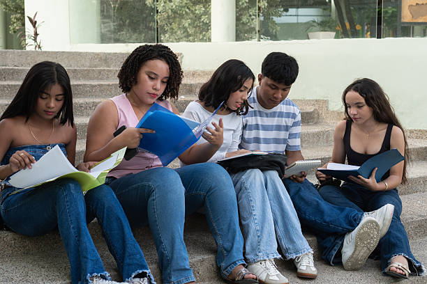 Group of students working together on a report or homework assignment and discovering different knowledge in the university library.