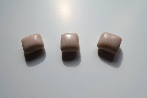 Line of three pink rectangular pieces of chewing gum