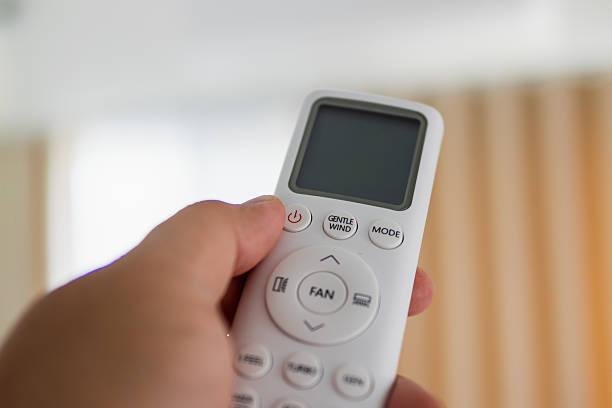 istock Operating a fan remote control indoor home setting action shot close-up view modern technology concept 2240082900
