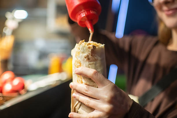 Young woman with shawarma in the evening outdoors