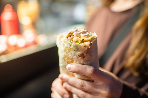 Young woman with shawarma in the evening outdoors