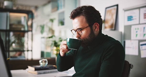 istock Business man, coffee or drink in office with morning start, break or relax for caffeine boost. Cup, espresso or warm beverage with male person for energy or thirst, rest or pause in work day for tea 2240085974
