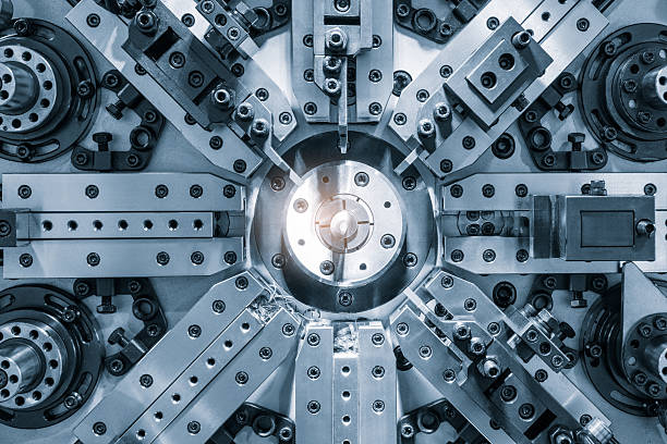 istock A complex machine with many parts and a bright light shining on it. The light is located in the center of the machine, illuminating the intricate design 2240087216