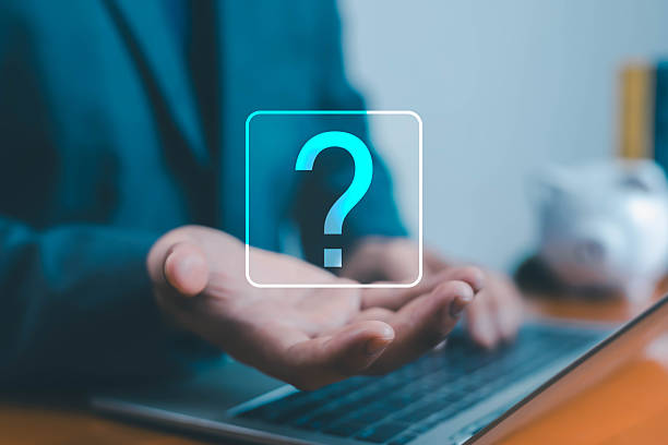 istock Businessman holding virtual question mark icon above laptop, concept of problem solving, decision making, business uncertainty, and digital thinking in modern technology. 2240087295