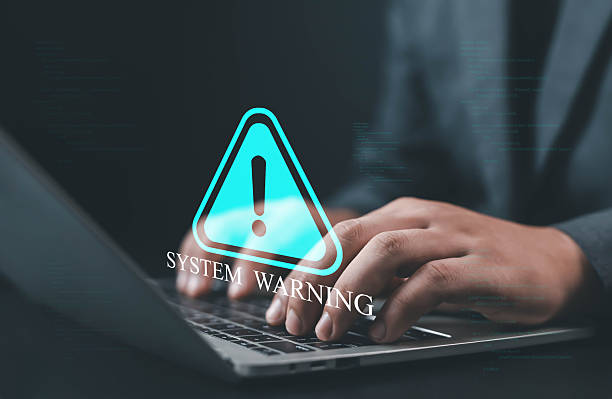 istock Businessman typing on laptop with virtual system warning icon, concept of cybersecurity alert, system error, data protection risk, and digital security management in modern technology. 2240087475