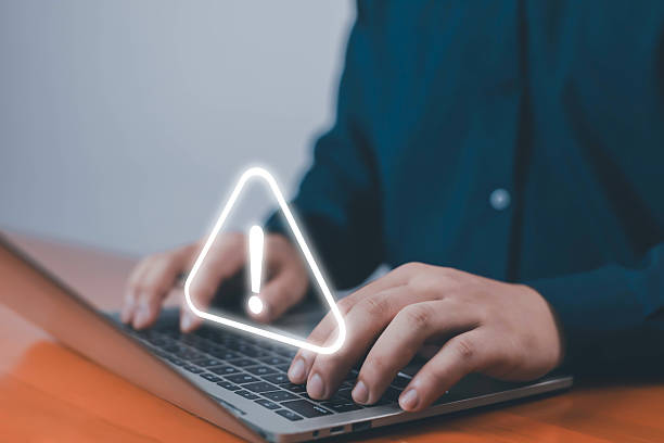 istock Businessman typing on laptop with virtual warning icon, concept of cybersecurity alert, data protection risk, online error, and digital safety awareness in modern business technology. 2240087520
