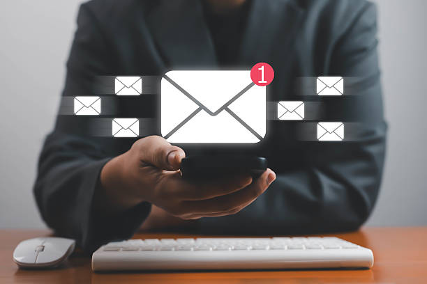 istock Businessman using smartphone with digital email icons and new message notification, concept of online communication, email marketing, and business technology in modern office with new message 2240087580
