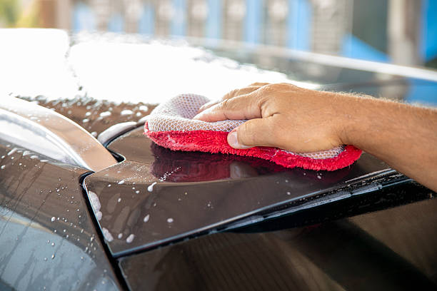 istock Man washing a car outer with soft sponge and soap foam 2240087682