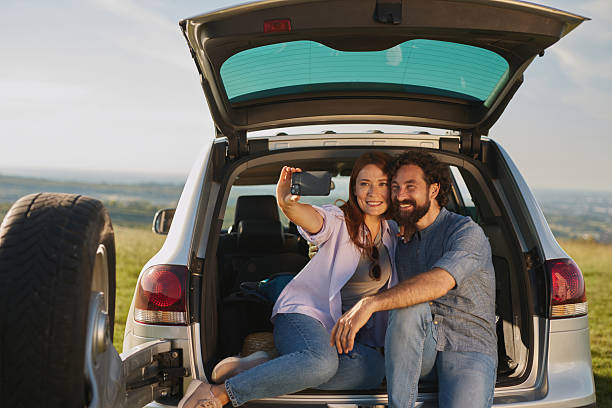 istock Couple taking a selfie during a relaxing road trip picnic 2240090999
