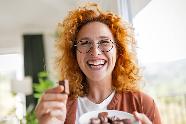 Smiling Redhead Lady Enjoying a Chocolate Treat