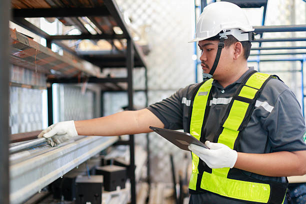 istock Engineer or warehouse staff wearing safety gear inspecting inventory on a shelf using a digital tablet in a factory, representing logistics management, warehouse operations, and stock control 2240091206