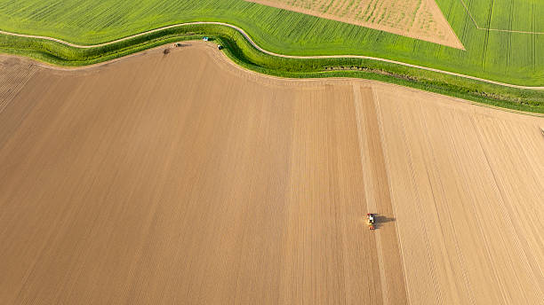 istock Tractor Planting Seeds on Vast Agricultural Field in Springtime 2240092818