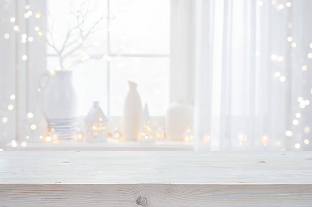 istock Bleached wooden Christmas table top for your product presentation on blurred window festive interior decor background 2240093384