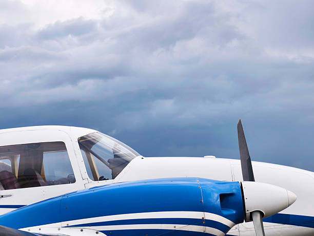 istock Small Propeller Aircraft Cockpit With Blue Body Under Dramatic Cloudy Sky – Close View 2240094481