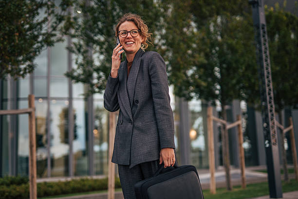 istock Businesswoman talking on phone walking to work 2240094676