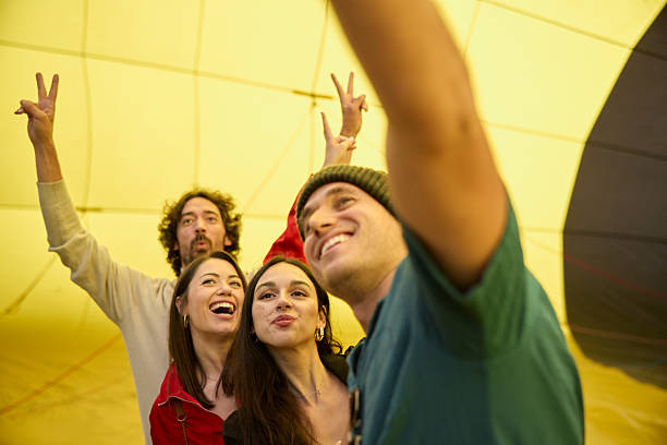istock Two couples pose for a selfie before embarking in a hot air balloon adventure trip. 2240094789