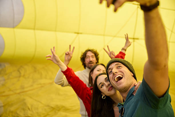 istock Two couples pose for a selfie before embarking in a hot air balloon adventure trip. 2240094802