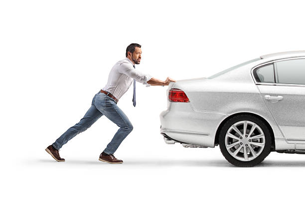 istock Full length profile shot of a man pushing a car 2240096156