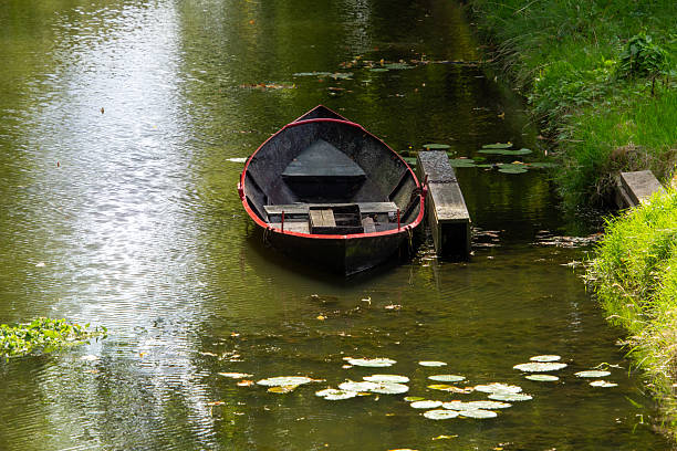 Still life with a boat at the waterside in a ditch in the Netherlands