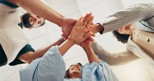 istock Hands, stack and team at office with low angle, support or synergy with goals in circle at startup. People, group and huddle at workplace for celebration, success or collaboration at creative agency 2240096899